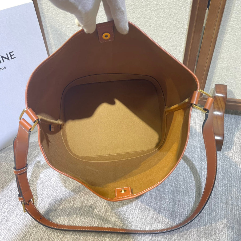 CELINE BUCKET 33 IN BLACK TRIOMPHE CANVAS AND BRONZE BROWN CALFSKIN TRIM