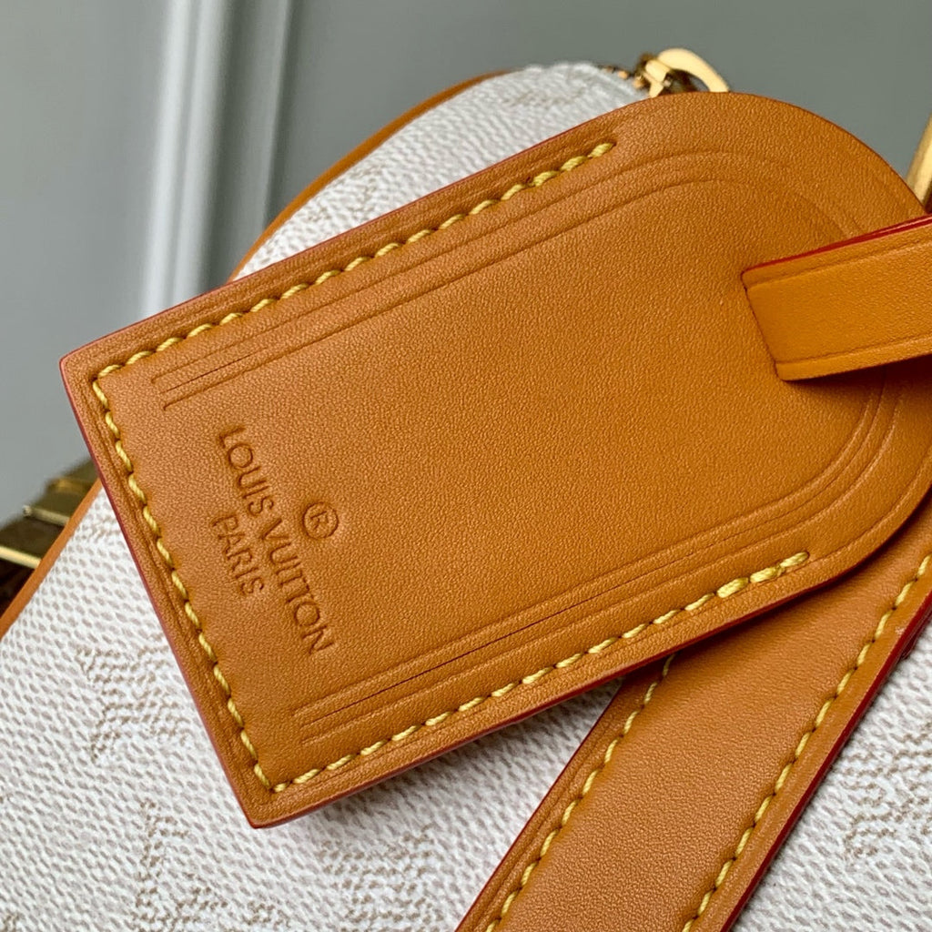 LOUIS VUITTON KEEPALL BANDOULIÈRE 25 IN WHITE MONOGRAM HERITAGE CANVAS BRWON CALFSKIN
