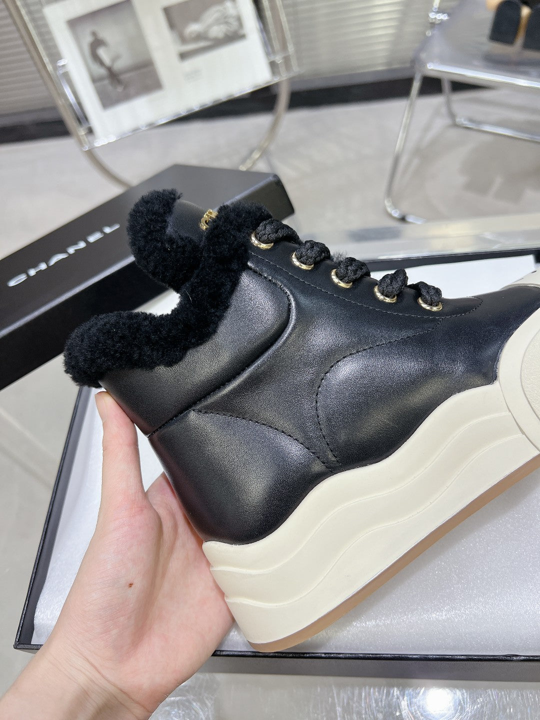 CHANEL MARTIN BOOTS IN BLACK CALFSKIN AND LAMB FUR LINING