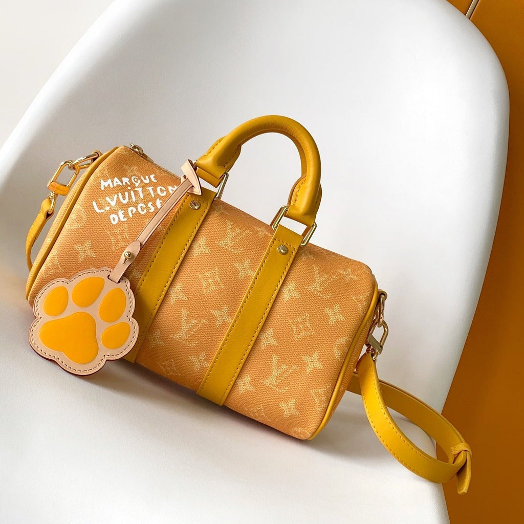 LOUIS VUITTON KEEPALL BANDOULIÈRE 25 IN ORANGE MONOGRAM HERITAGE CANVAS