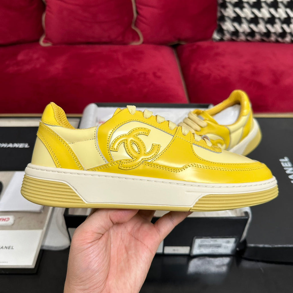 CHANEL TRAINERS IN BRIGHT YELLOW SHINY CALFSKIN